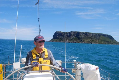 The basalt massif, known locally as the Nut, is clearly visible behind Geroge Shaw as he sails away from Stanley after last years race ©  John Curnow